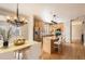Kitchen with stainless steel appliances, granite countertops and island, hardwood floors, and dining room at 3080 Madison Ln, Broomfield, CO 80023