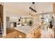 Kitchen island featuring granite countertop and hardwood floors with views to the living room and dining room at 3080 Madison Ln, Broomfield, CO 80023