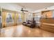 View of the living room with hardwood floors, large windows with draperies, and views to the kitchen and dining room at 3080 Madison Ln, Broomfield, CO 80023
