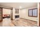 Living room with decorative fireplace and rustic floors at 3080 Madison Ln, Broomfield, CO 80023