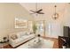 Bright living room with vaulted ceiling, hardwood floors, modern light fixture, and large window at 3080 Madison Ln, Broomfield, CO 80023