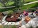 Outdoor patio with lounge chairs and stone firepit, overlooking landscaped yard and walkway at 3080 Madison Ln, Broomfield, CO 80023
