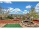 Backyard featuring a stone fire pit, small gazebo, and terraced landscaping at 15785 W Second Ave, Golden, CO 80401