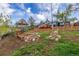 Sloping backyard with a gazebo, garden beds, and stone accents at 15785 W Second Ave, Golden, CO 80401