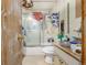 Dated bathroom featuring a shower/tub with a sliding door and a stained vanity at 15785 W Second Ave, Golden, CO 80401