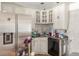 Bright kitchen featuring a stainless steel refrigerator, white cabinets, sink, and black dishwasher at 15785 W Second Ave, Golden, CO 80401