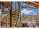 Rustic wooden spiral staircase leading to a patio overlooking a nice view at 15785 W Second Ave, Golden, CO 80401