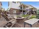 Backyard featuring a stone fire pit, comfortable seating, and a well-manicured lawn at 7756 S Eaton Park Ct, Aurora, CO 80016