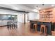Entertainer's finished basement with bar area featuring seating, wood flooring, and access to outside patio at 7756 S Eaton Park Ct, Aurora, CO 80016