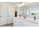 Double vanity bathroom with stone countertops, stylish lighting, and a view to a tub and walk-in shower at 7756 S Eaton Park Ct, Aurora, CO 80016