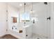 Elegant bathroom features a soaking tub, a glass-enclosed shower, and a view from the window at 7756 S Eaton Park Ct, Aurora, CO 80016