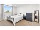 Bright bedroom with large window, neutral walls, and elegant furnishings, creating a cozy retreat at 7756 S Eaton Park Ct, Aurora, CO 80016
