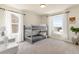Bright bedroom featuring bunk beds, neutral carpet, natural light, and neighborhood views at 7756 S Eaton Park Ct, Aurora, CO 80016