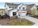 Stunning two-story home with a stone-accented facade, well-manicured lawn, and an attached two-car garage at 7756 S Eaton Park Ct, Aurora, CO 80016