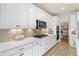 Well-equipped kitchen with modern appliances, ample storage, and stylish backsplash at 7756 S Eaton Park Ct, Aurora, CO 80016