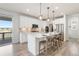 Bright kitchen featuring stainless steel appliances, quartz countertops, and a large island at 7756 S Eaton Park Ct, Aurora, CO 80016