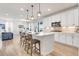 Open-concept kitchen with stainless steel appliances, large center island, and adjacent living area at 7756 S Eaton Park Ct, Aurora, CO 80016