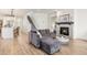 Cozy living room with a stone fireplace, plush seating, and hardwood floors at 7756 S Eaton Park Ct, Aurora, CO 80016