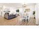 Open-concept living and dining area with a fireplace, comfortable seating, and hardwood floors at 7756 S Eaton Park Ct, Aurora, CO 80016