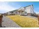 Expansive backyard with a lush lawn, gravel landscaping, a charming porch, and appealing home exterior at 1884 Myron Ct, Erie, CO 80516