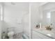 Clean, well-lit bathroom with tile flooring, a single sink vanity, a toilet, and a shower with a curtain at 1884 Myron Ct, Erie, CO 80516