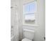 Clean bathroom features a toilet and shower/tub combo with bright natural light at 1884 Myron Ct, Erie, CO 80516