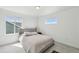 Bright bedroom with a large bed, carpet flooring, and large windows showcasing natural light and providing scenic views at 1884 Myron Ct, Erie, CO 80516