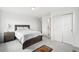 Comfortable bedroom featuring a closet, a bed with a nightstand, and neutral carpet at 1884 Myron Ct, Erie, CO 80516