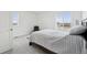 Inviting bedroom featuring a comfy bed and large windows with peaceful views at 1884 Myron Ct, Erie, CO 80516