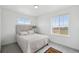 Bright bedroom with a comfortable bed, carpet flooring, and windows showcasing natural light and providing scenic views at 1884 Myron Ct, Erie, CO 80516