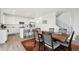 Bright dining area featuring an open layout, wooden table, and kitchen island with barstool seating at 1884 Myron Ct, Erie, CO 80516