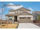 Charming two-story home with a two-car garage, inviting porch, and complementary neutral color palette at 1884 Myron Ct, Erie, CO 80516