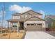 Charming two-story home showcasing a well-maintained front yard and a welcoming covered porch at 1884 Myron Ct, Erie, CO 80516