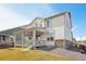 Rear exterior view of a modern house featuring a well-kept lawn, appealing architecture, and inviting porch area at 1884 Myron Ct, Erie, CO 80516