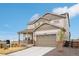 Inviting two-story home boasting a lovely facade, attached garage, and green lawn at 1884 Myron Ct, Erie, CO 80516