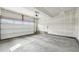 Spacious two car garage featuring an automatic door and concrete flooring, ready for your vehicles and storage needs at 1884 Myron Ct, Erie, CO 80516