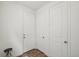 Hallway with a wood-look floor and a small wrought iron table at 1884 Myron Ct, Erie, CO 80516