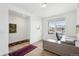 A home office with a wooden floor, gray desk, and a large window with a view at 1884 Myron Ct, Erie, CO 80516
