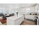 The kitchen island has a quartz countertop and is adjacent to the dining room and living area at 1884 Myron Ct, Erie, CO 80516