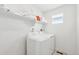 Functional laundry room featuring a washer, dryer, and shelving, providing a convenient space for laundry tasks at 1884 Myron Ct, Erie, CO 80516