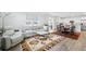 Open-concept living area featuring a large window, modern furniture, and seamless access to the kitchen at 1884 Myron Ct, Erie, CO 80516