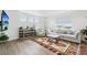 Bright living room with white walls, wood floors, stylish rug, and comfortable seating at 1884 Myron Ct, Erie, CO 80516