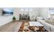 Bright living room with white walls, wood floors, stylish rug, and comfortable seating at 1884 Myron Ct, Erie, CO 80516