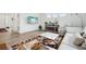 Bright living room with white walls, wood floors, stylish rug, and comfortable seating at 1884 Myron Ct, Erie, CO 80516
