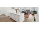 Open concept area showing the kitchen island, dining table, living room, and staircase at 1884 Myron Ct, Erie, CO 80516