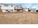 Spacious backyard featuring a large deck, shed, and potential for landscaping at 10930 Albion Ct, Thornton, CO 80233