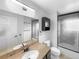 Updated bathroom with a granite countertop, shower with glass doors, and modern fixtures at 10930 Albion Ct, Thornton, CO 80233