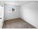 Cozy bedroom with neutral carpet, white walls and one window at 10930 Albion Ct, Thornton, CO 80233