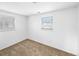 Bedroom with neutral carpet, two windows with blinds, and white walls at 10930 Albion Ct, Thornton, CO 80233