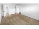A bedroom with carpet, white walls, and a closet with doors leading to the bathroom at 10930 Albion Ct, Thornton, CO 80233